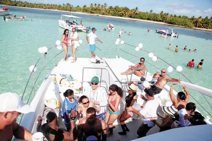 From Bavaro, Punta Cana: Boat Party, Snorkeling, Drinks, Snacks, and Transportation - Boarding Bávaro Beach: party energy on a catamaran