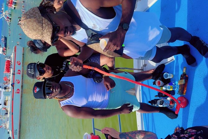 Hip Hop Adult Only Party Boat with Unlimited drinks & Sandba stop - Bavaro Beach plan: snorkeling, a slide, and a party run to the natural pool